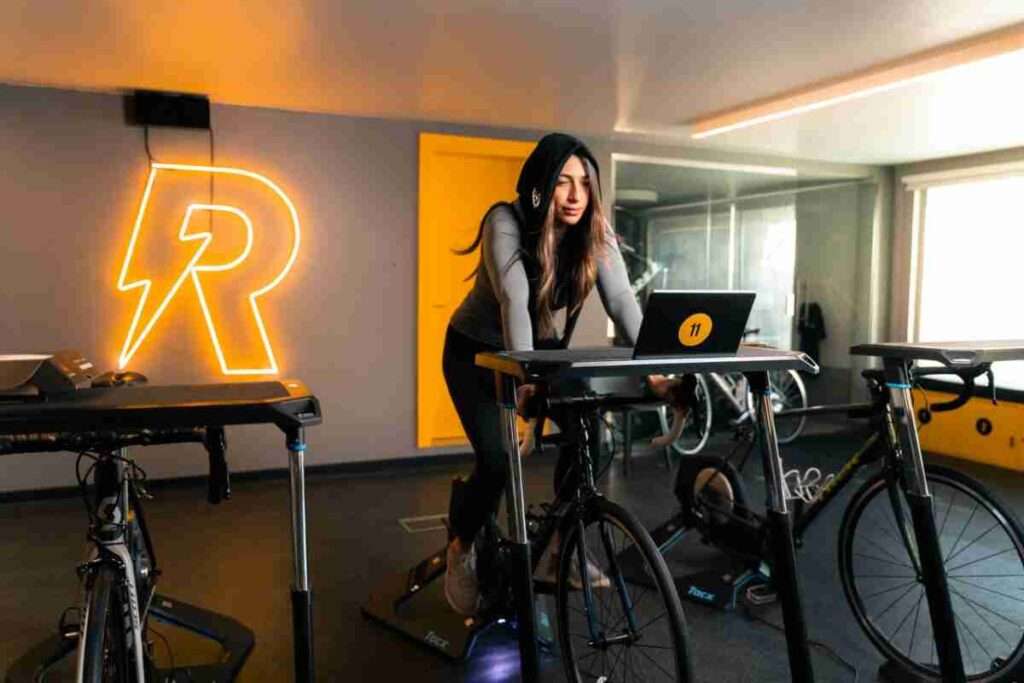Crossfit zu Yoga: Eine streikende Fußsohle und eine neue Routine 1 A woman in sportswear exercises on a stationary bike in an indoor gym in Bahrain.