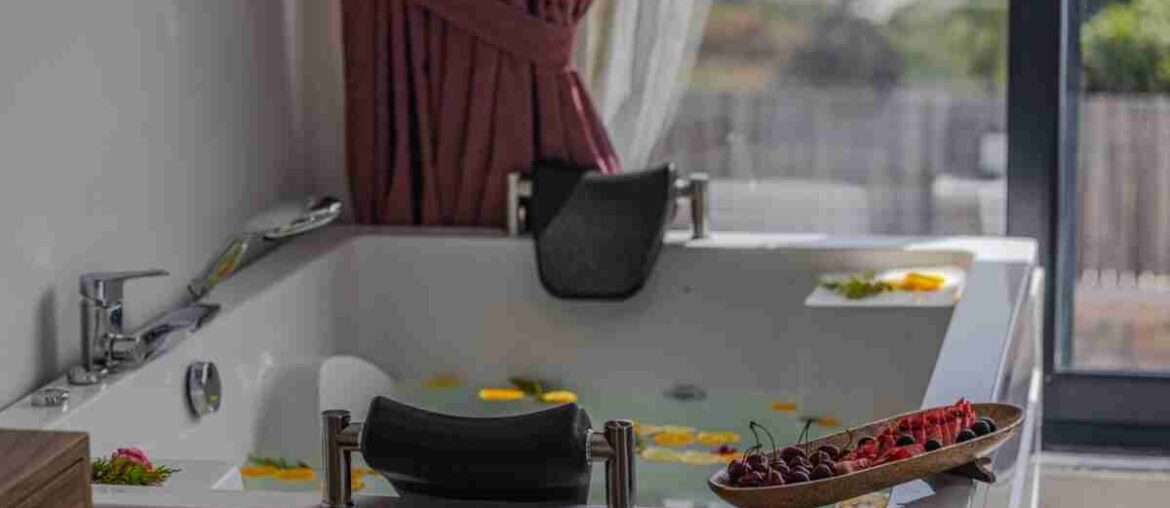 Relaxing indoor bath scene with fruits and petals, perfect for spa or luxury home vibes.
