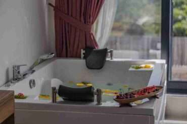 Relaxing indoor bath scene with fruits and petals, perfect for spa or luxury home vibes.